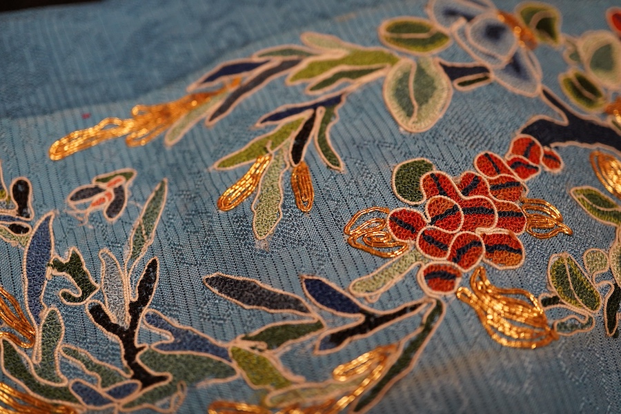 A pair of Chinese silk embroidered sleeve bands and a small collection of black lace stoles, etc.